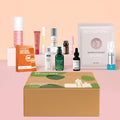 Skincare gift box with kraft lid, plus assorted lotion and serum bottles