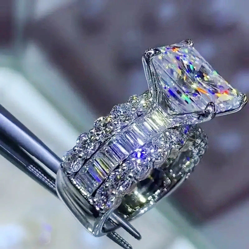 Zircon-inlaid geometric ring with prong-set rectangular centerpiece and sparkling side stones