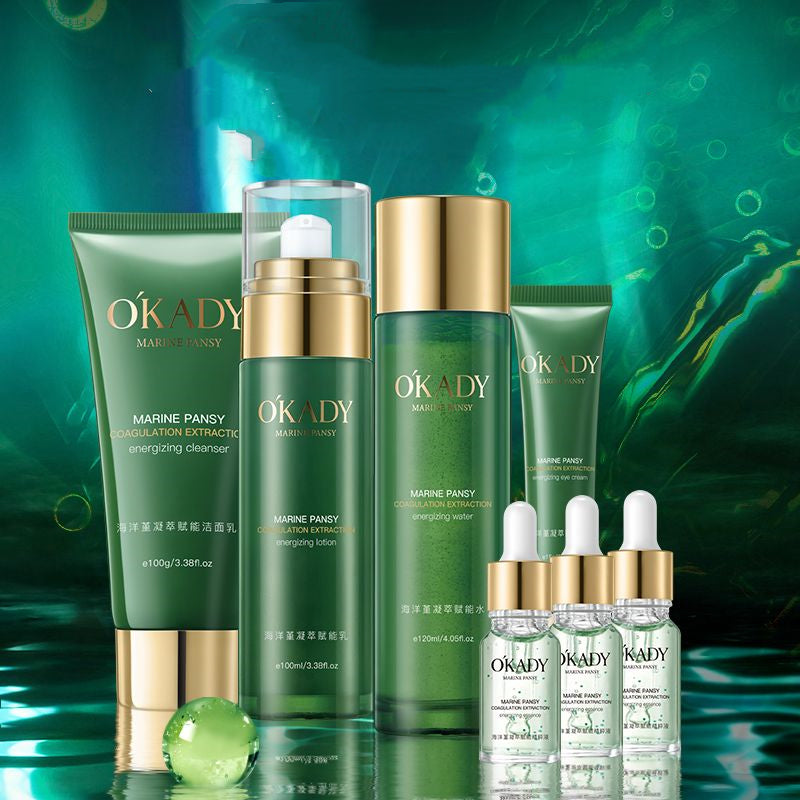 Okady Marine Pansy skincare set with green tubes, bottles, and gold-capped jars