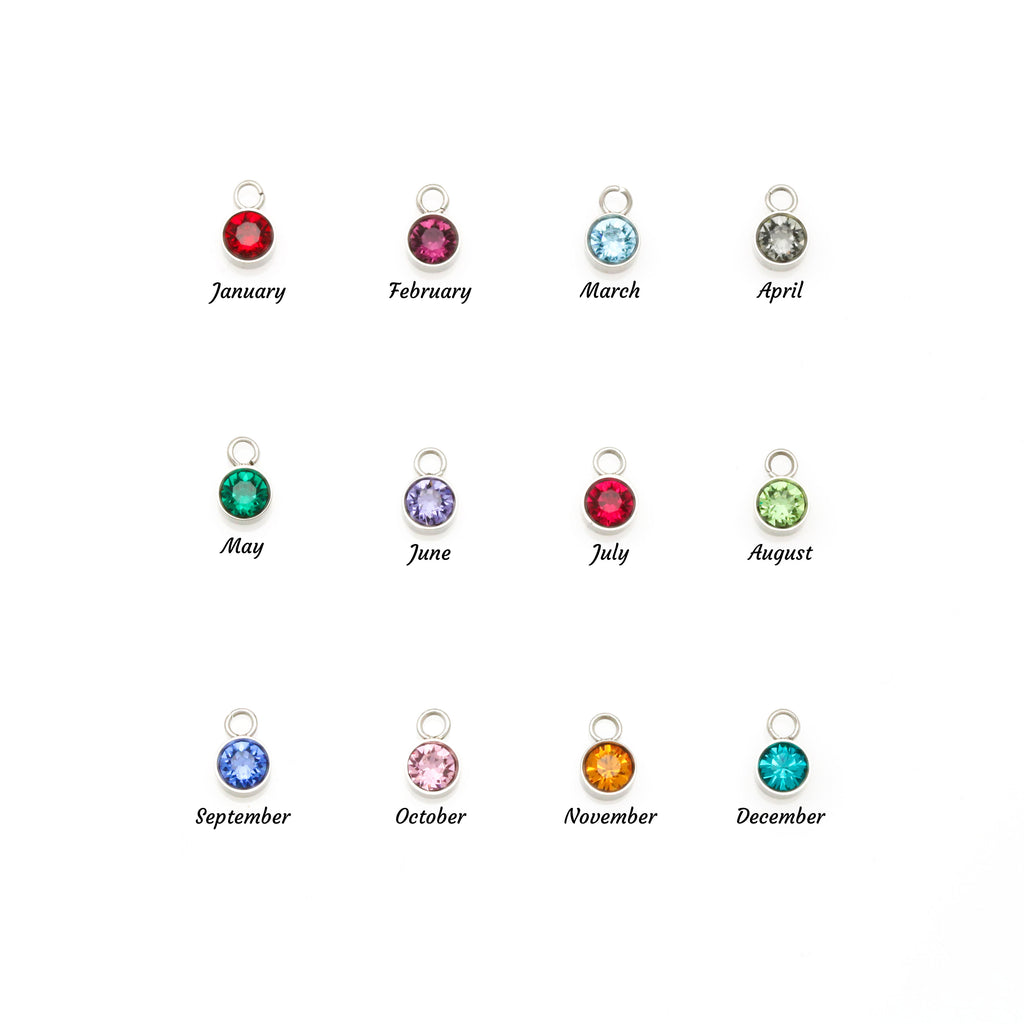 Birthstone charm display with round gems labeled January to December on small rings