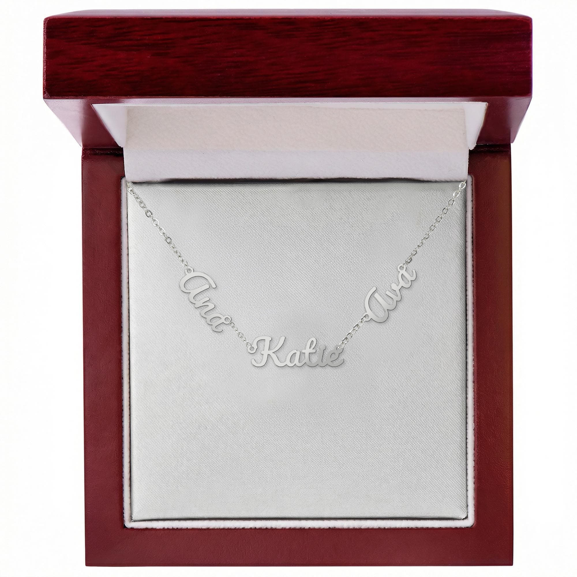 Silver-tone personalized name necklace with three script charms in a red display box