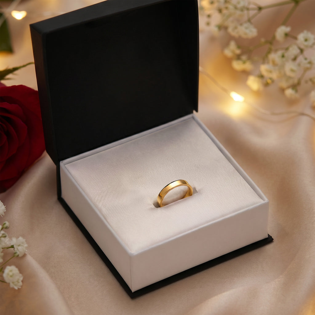 Gold-finish engraved ring displayed in an open gift box