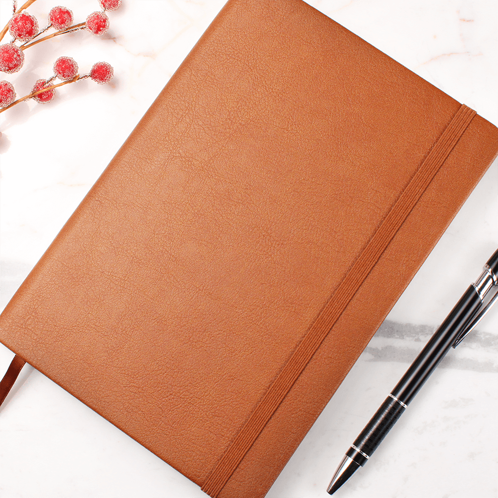 Orange journal with elastic closure band and textured cover surface
