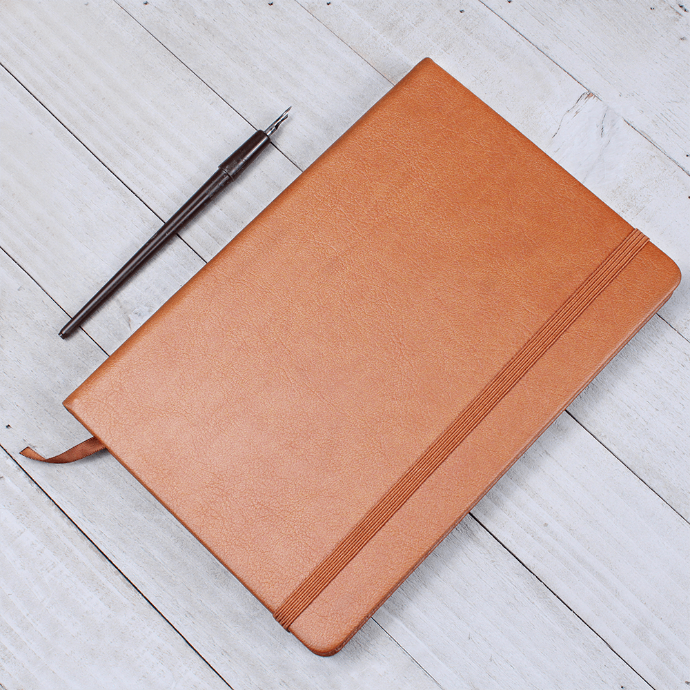 Orange journal with elastic closure band and ribbon bookmark