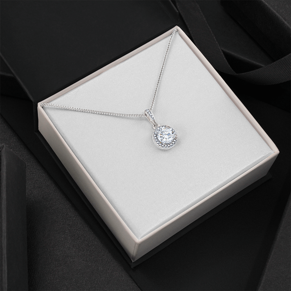 Round crystal halo pendant necklace with silver-tone chain placed in a gift box