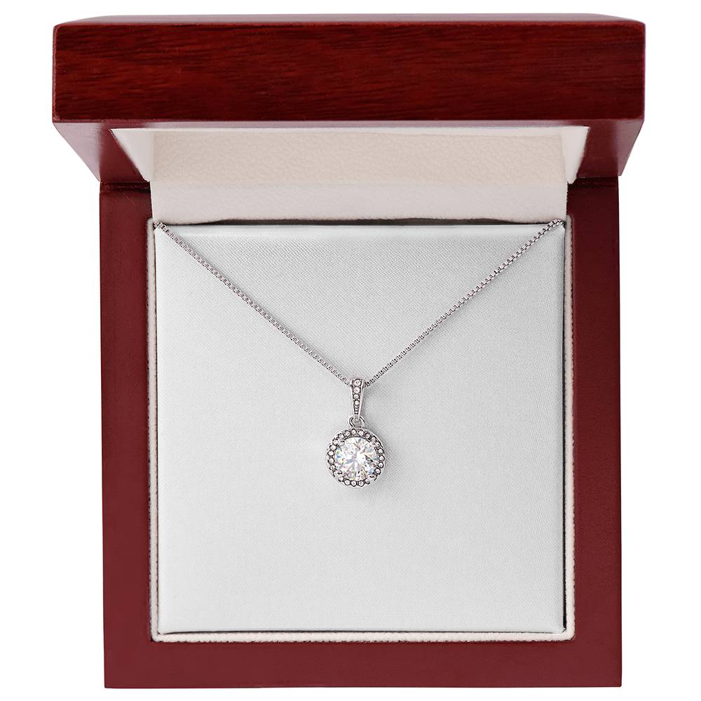 Silver-tone round crystal halo pendant necklace displayed in a red jewelry box
