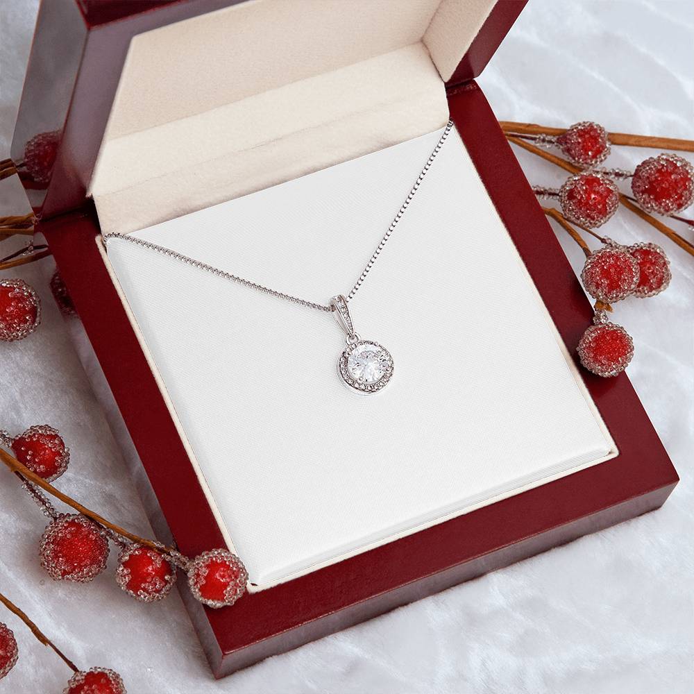 Silver-tone round crystal halo pendant necklace on a thin chain in a red box