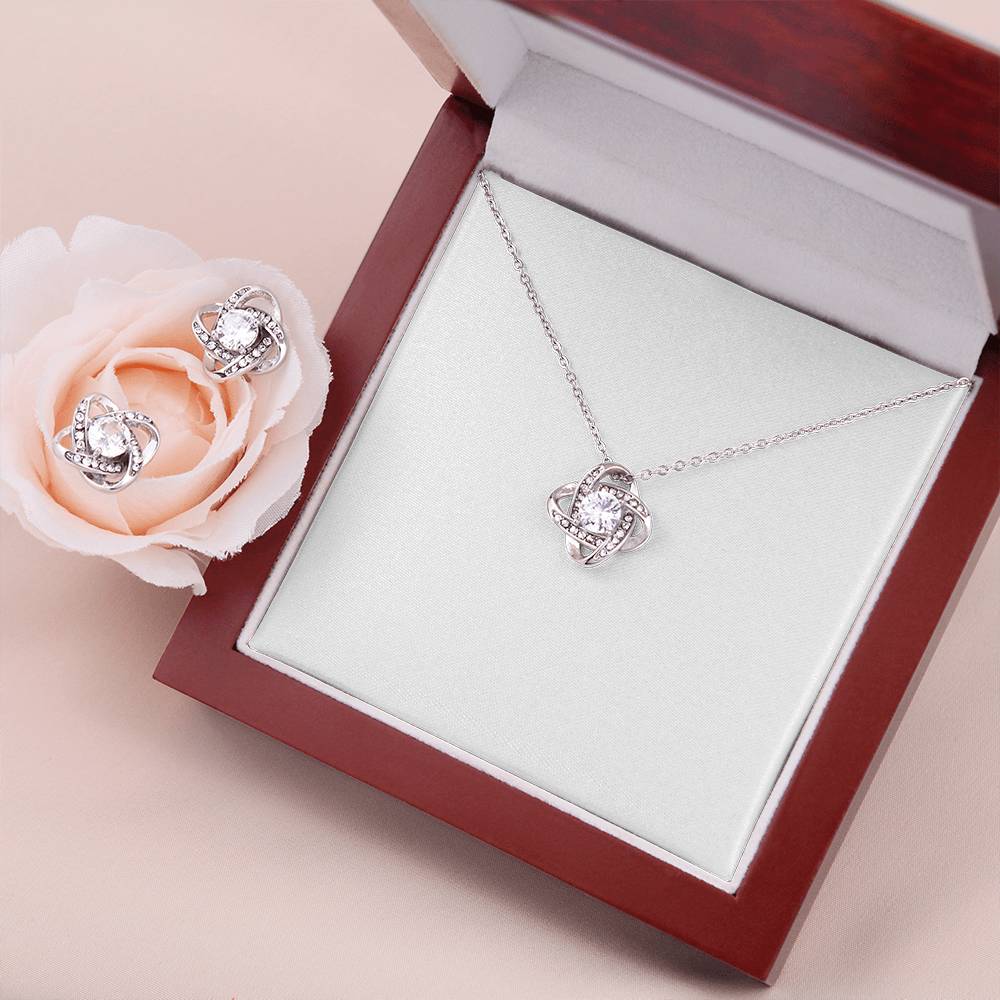 Silver-tone heart love-knot pendant necklace and stud earrings with floral accent
