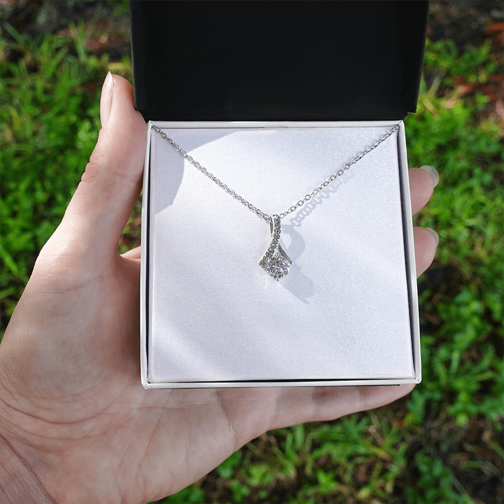 White gold necklace with teardrop pendant and round clear stone, delicate chain