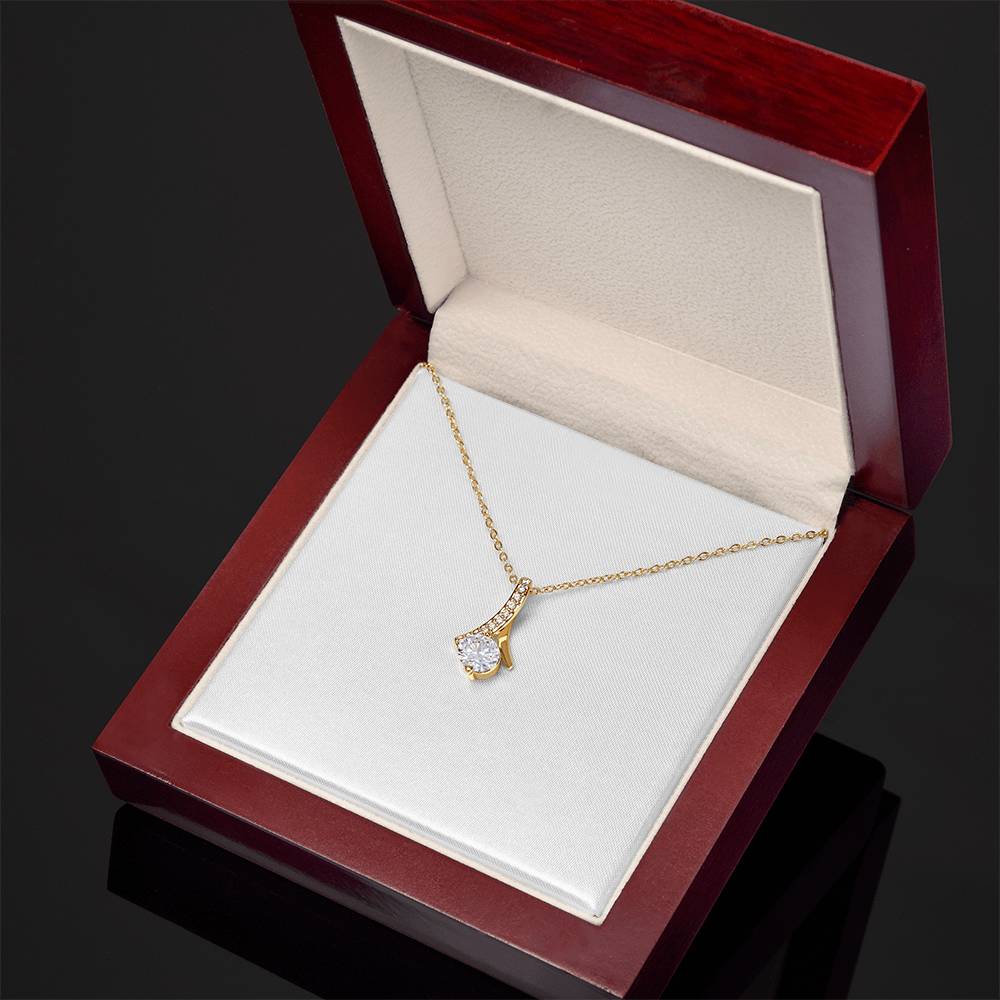 Yellow gold necklace with teardrop pendant and clear round stone, delicate chain