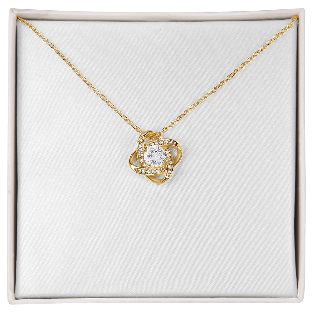 Love knot pendant necklace in yellow gold tone with round clear center stone