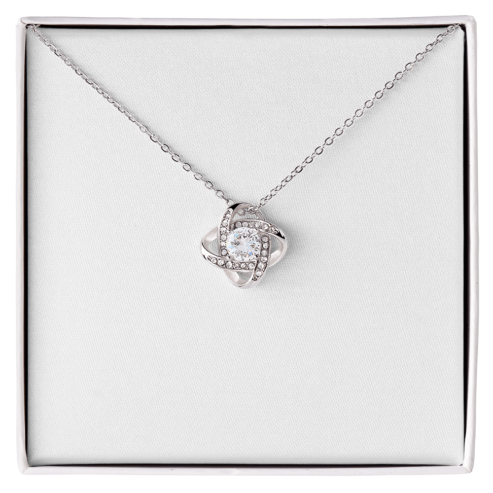 Love knot pendant necklace in silver-tone with round clear stone and halo details