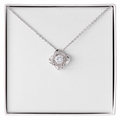 Love knot pendant necklace in silver-tone with round clear stone and halo details