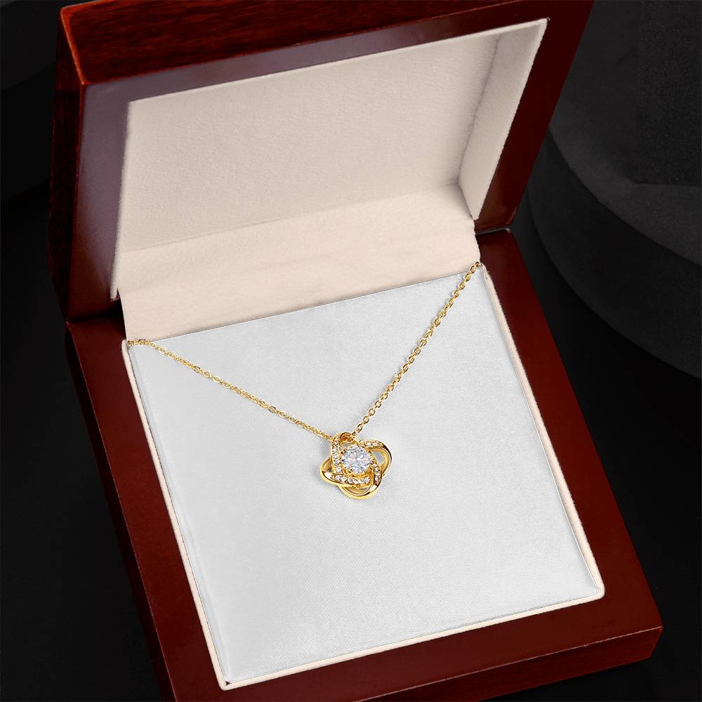Love knot pendant necklace in yellow gold tone with round clear stone on chain