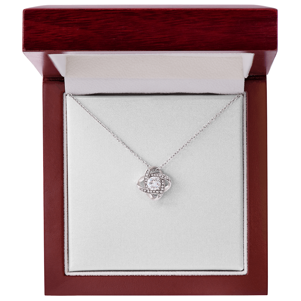 Love knot pendant necklace with round clear stone on silver chain, gift box view