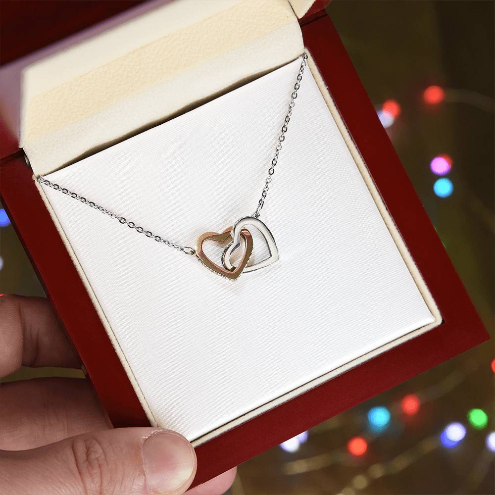 Interlocking hearts pendant necklace in rose and silver, on a chain