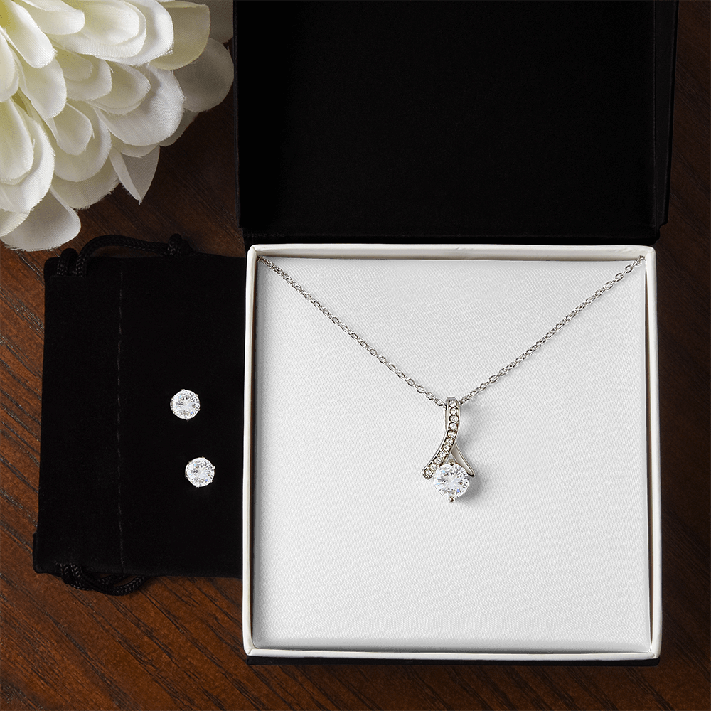 Necklace and earring set featuring teardrop pendant necklace and two sparkly studs