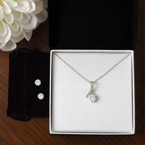 Necklace and earring set featuring teardrop pendant necklace and two sparkly studs