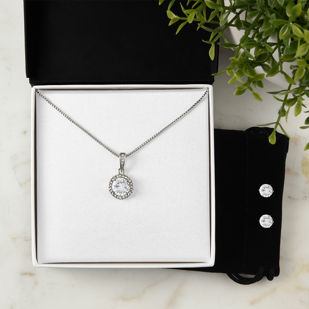 Necklace and earring set: round halo pendant on chain with two stud earrings.