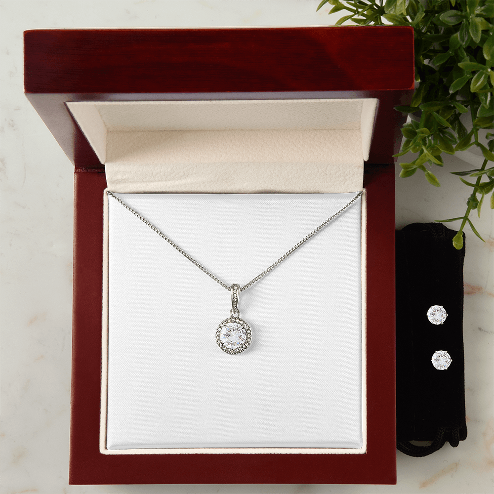 Necklace and earring set in a box; round halo pendant necklace and two stud earrings.