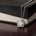Silver love-knot pendant with round clear stone, diamond accents, link chain