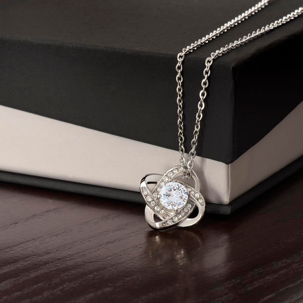 Silver love-knot pendant with round clear stone, diamond accents, link chain