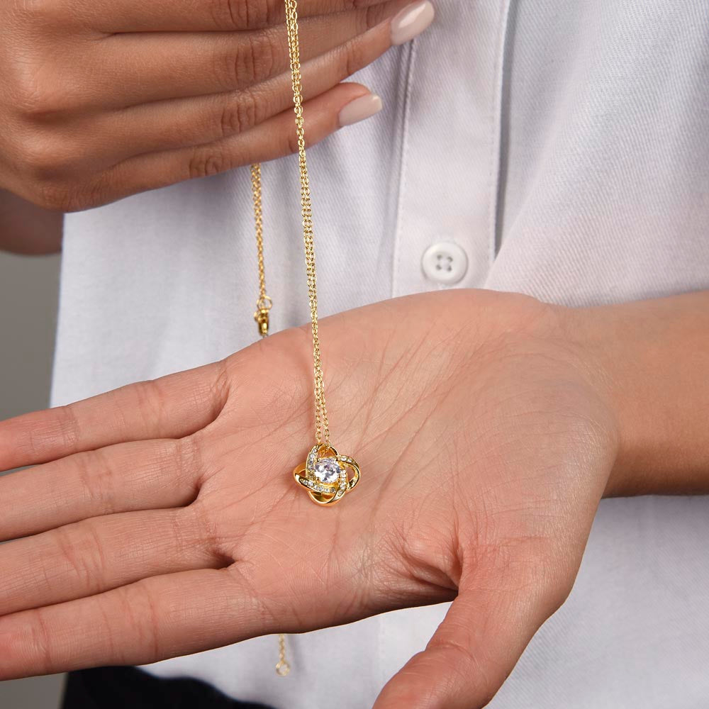 Gold love-knot pendant necklace with round clear stone and diamond halo, fine chain