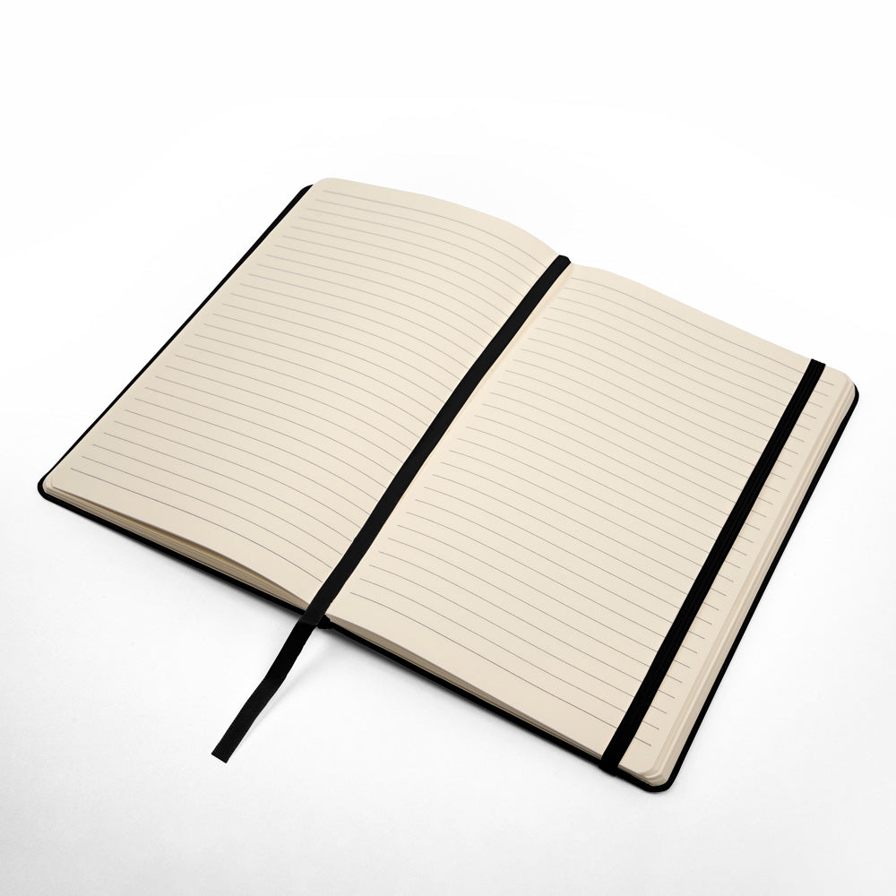 Open black hardcover journal with cream lined pages and black elastic strap