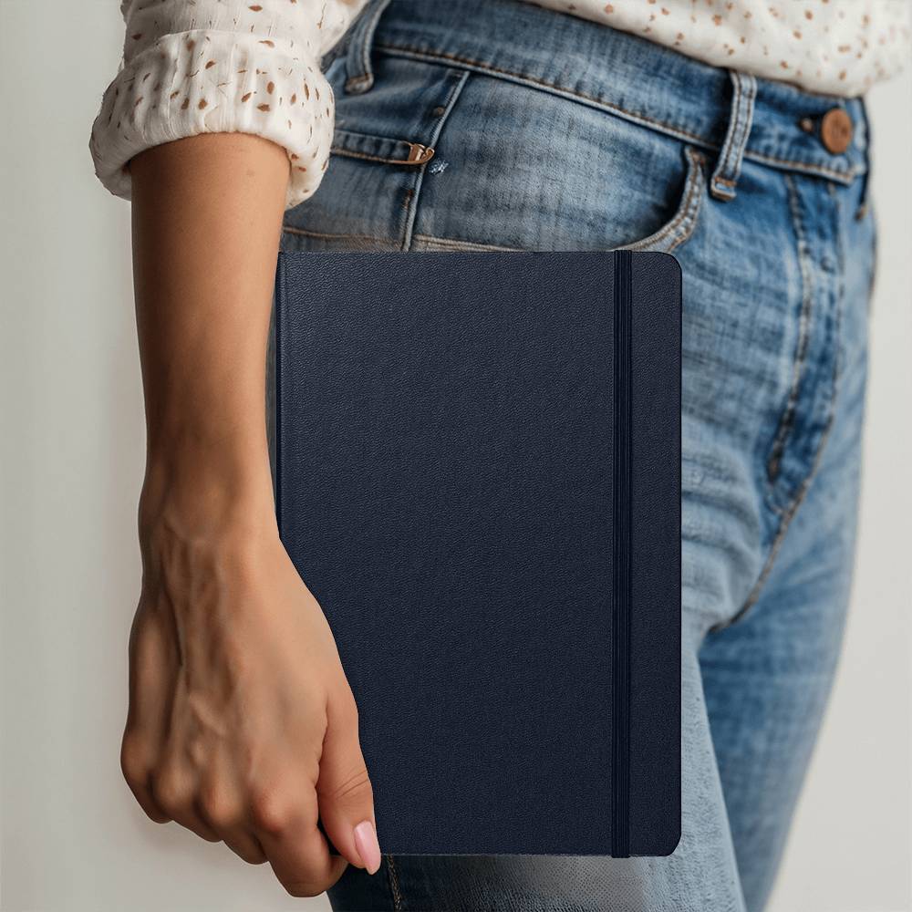 Navy Ambassador Bound journal held in hand, with stitched spine detail