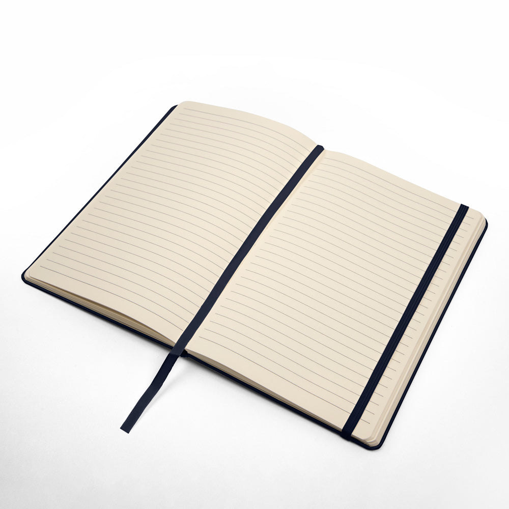 Open journal with beige lined pages and navy cover binding