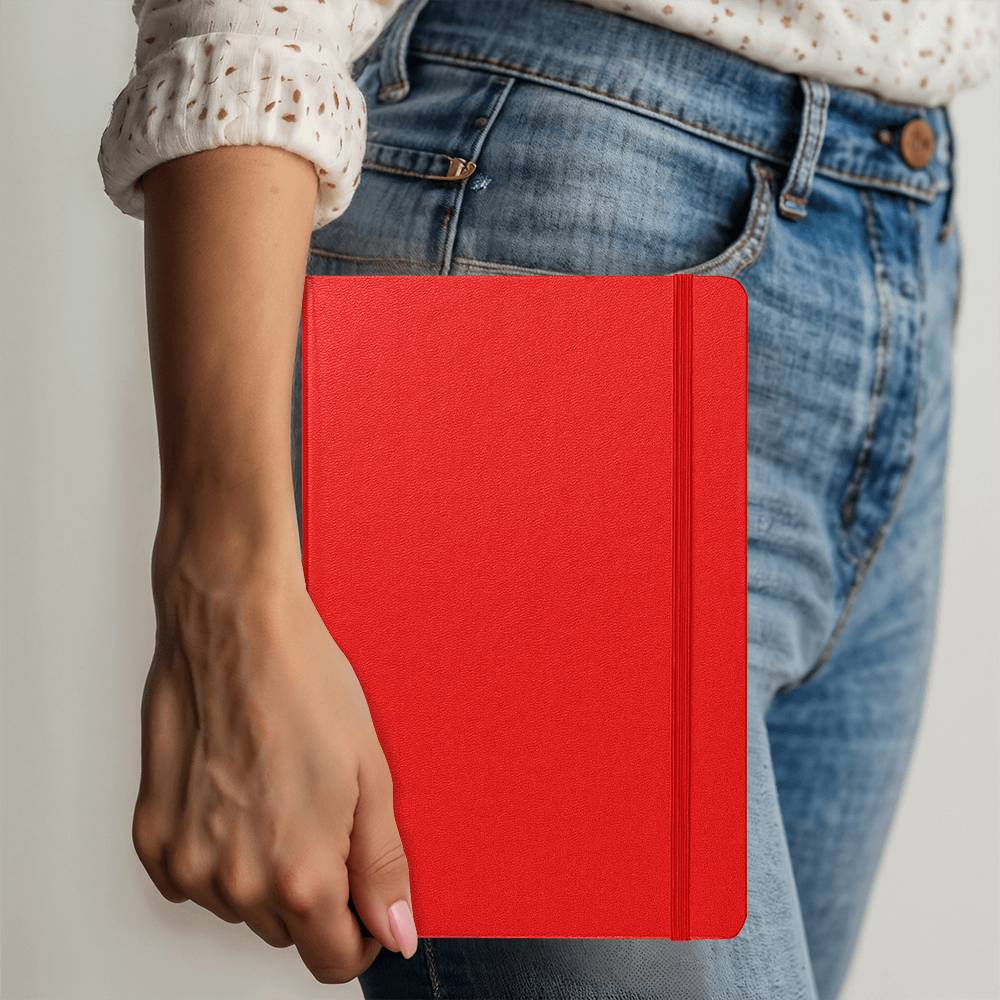 Red Ambassador Bound journal held in hand, with stitched spine detail