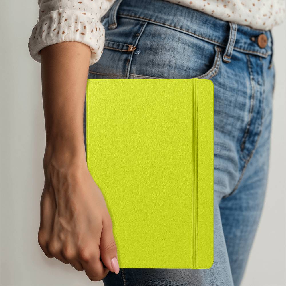 Lime green journal with stitched spine and elastic closure, held in a hand