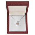Silver heart pendant necklace with small baby feet charm on a fine chain