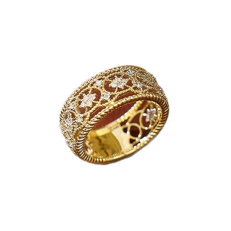 Gold-tone openwork ring with carved lattice pattern and beaded border edge
