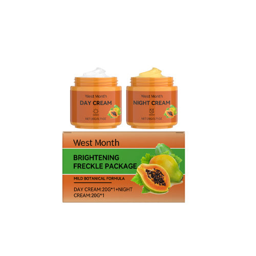 Facial cream set with two orange jars and brightening freckle package box